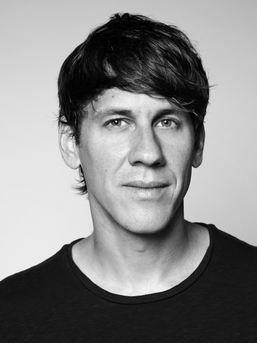 Black-and-white portrait of Dennis Crowley